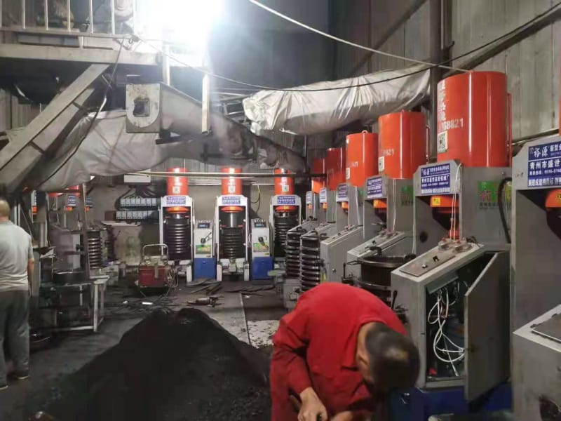 Customer workshop with oil sludge presses and oil collection drums