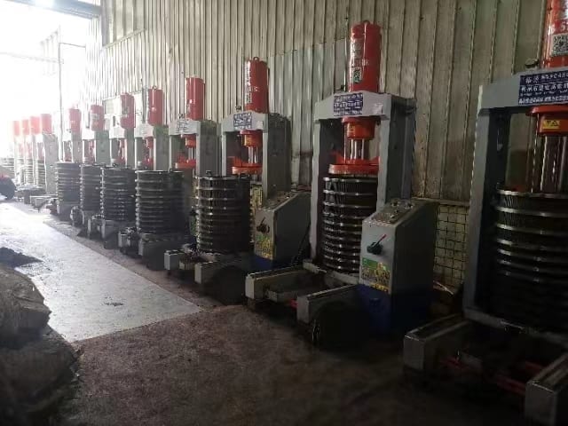 Multiple hydraulic presses lined up in a customer workshop