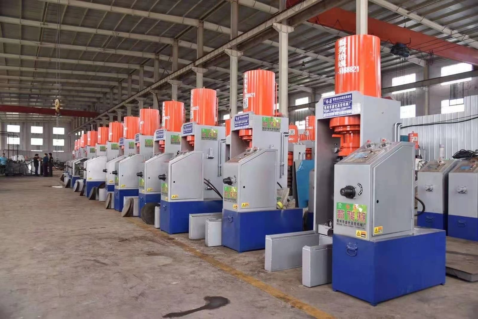 Hydraulic presses in a customer workshop with finished cakes ready for discharge